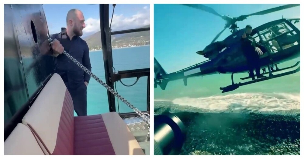 Бизнесмен пролетел над морем, стоя на шасси вертолета