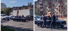 Голая женщина забралась на крышу машины и спровоцировала пробку