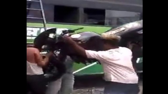 Индийский мужчина головой затащил мотоцикл на крышу автобуса