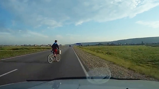 Велосипедист с канистрой в руке