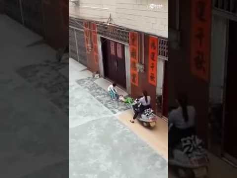 Женщина на скутере ездит по ногам ребенка