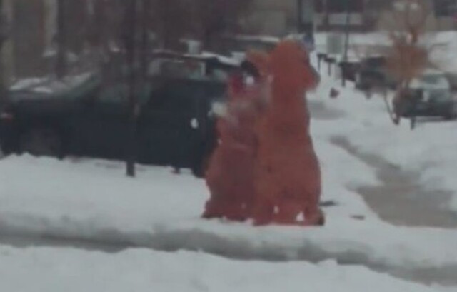 Два человека в костюме динозавра устроили снежный бой