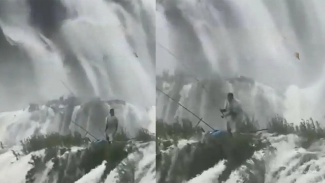 Мужчина ловил рыбу в водопаде